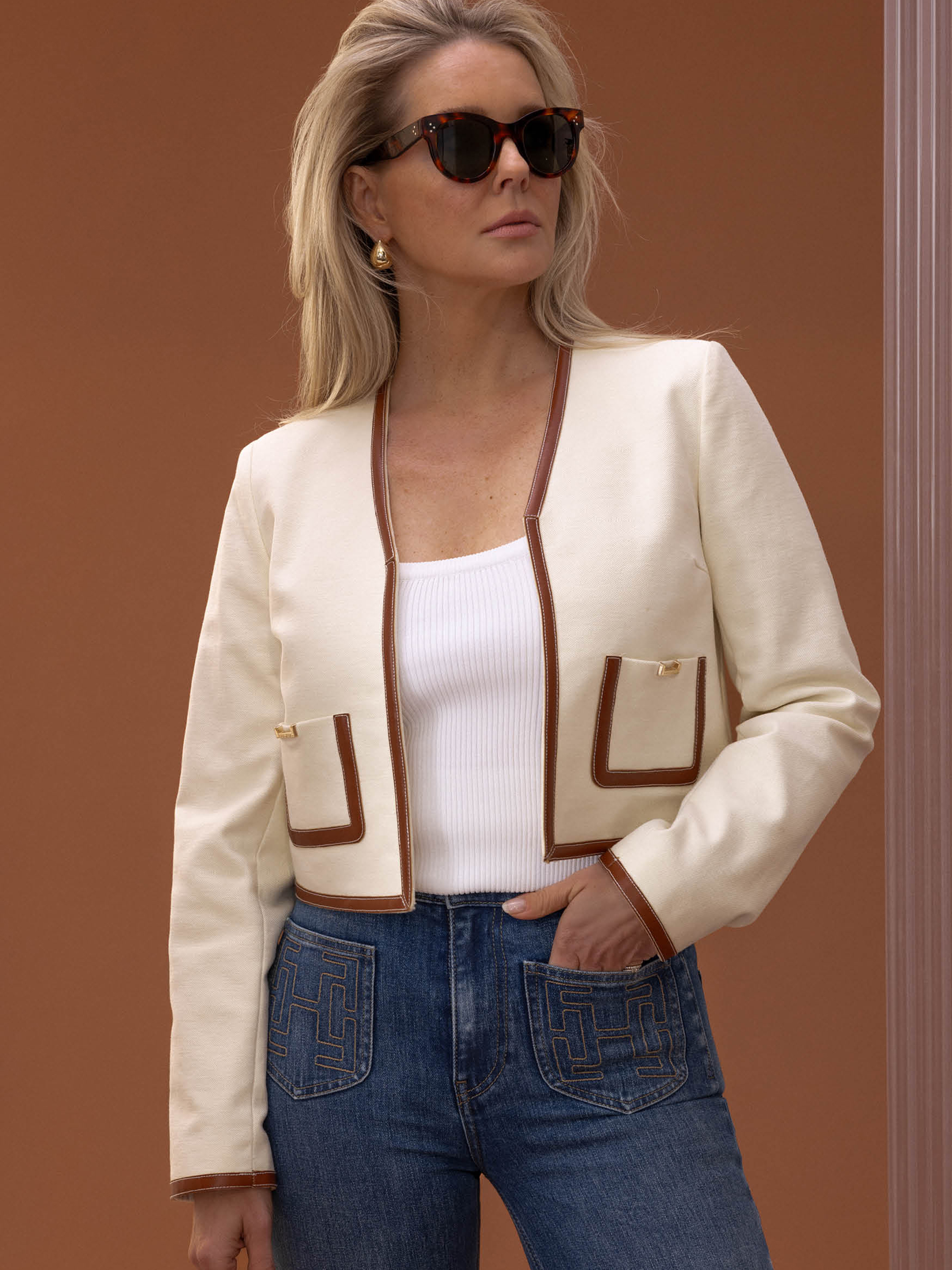 Short jacket with contrasting piping